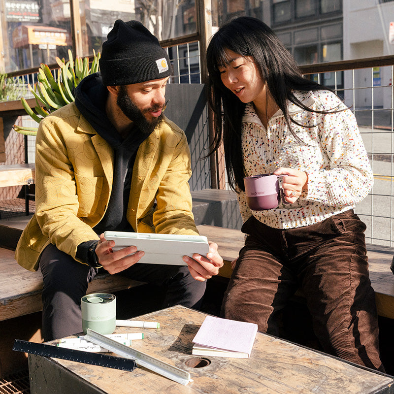12oz-rise-mug-b6 12oz_rise_coffee_mug_dusty_orchid_couple_city_patio_square.jpg