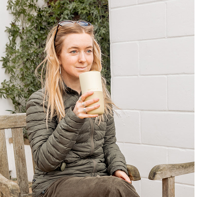 16oz-rise-tumbler-i0 16oz_rise_tumbler_wax_yellow_woman_seat_outside_square.jpg