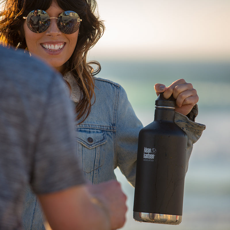 64oz-classic-with-loop-cap-l3 64oz_insulated_classic_black_beach_girl_hand_square.jpg