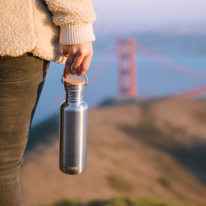 27oz-reflect-with-bamboo-cap-a2 K27SSLRF-BS-BAMBOO_reflect_bottle_bridge_lifestyle.jpg
